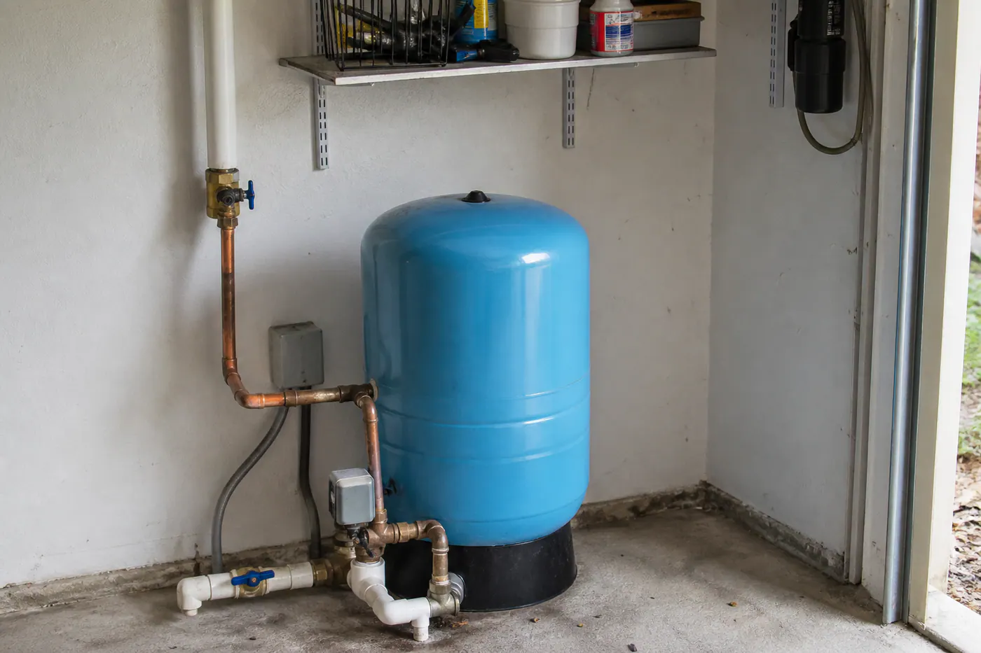 Well pressure tank, pressure switch, and gauge in a utility area